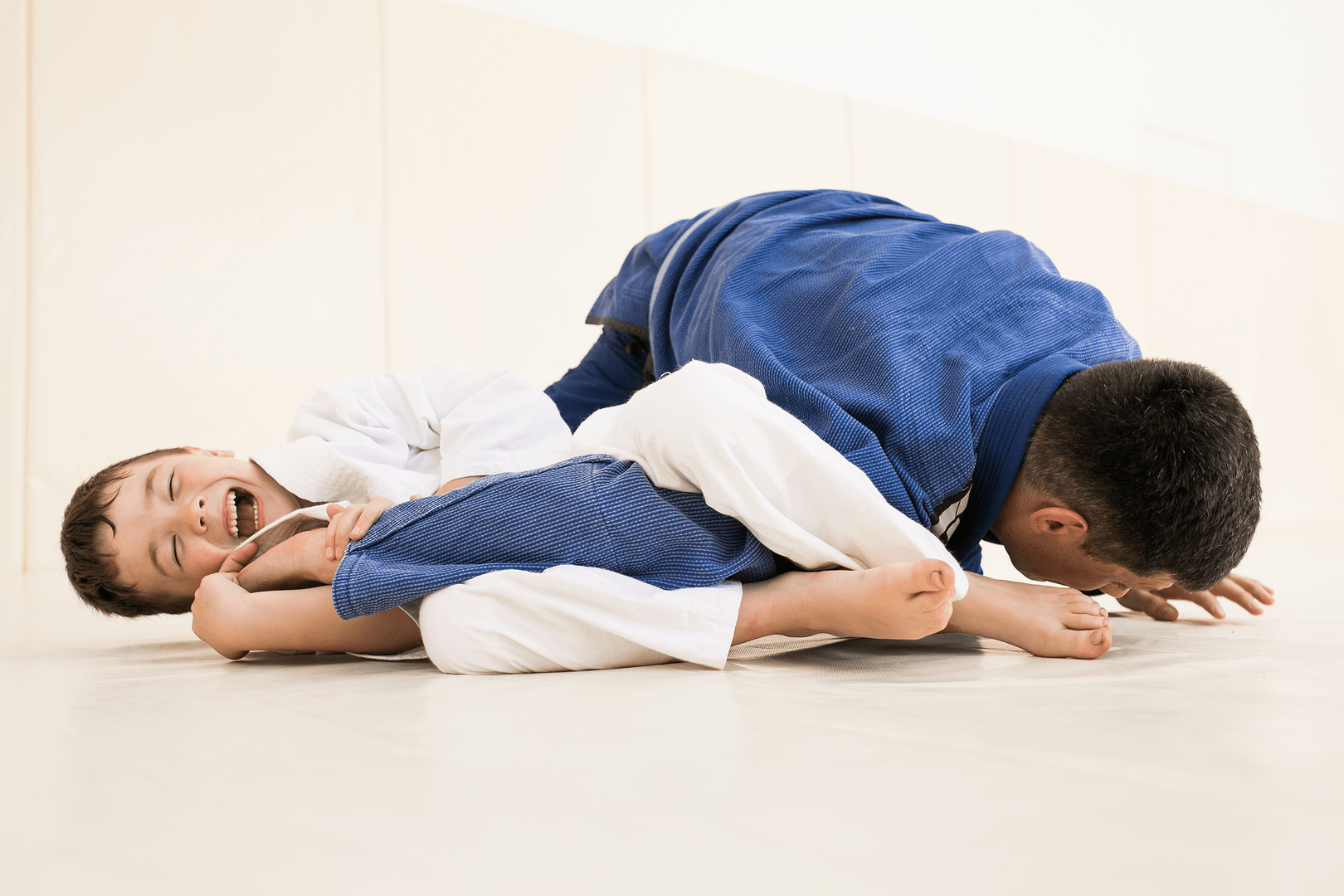 Two boys fighting and laughing